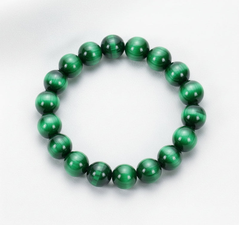 Green beaded bracelet on a white surface 