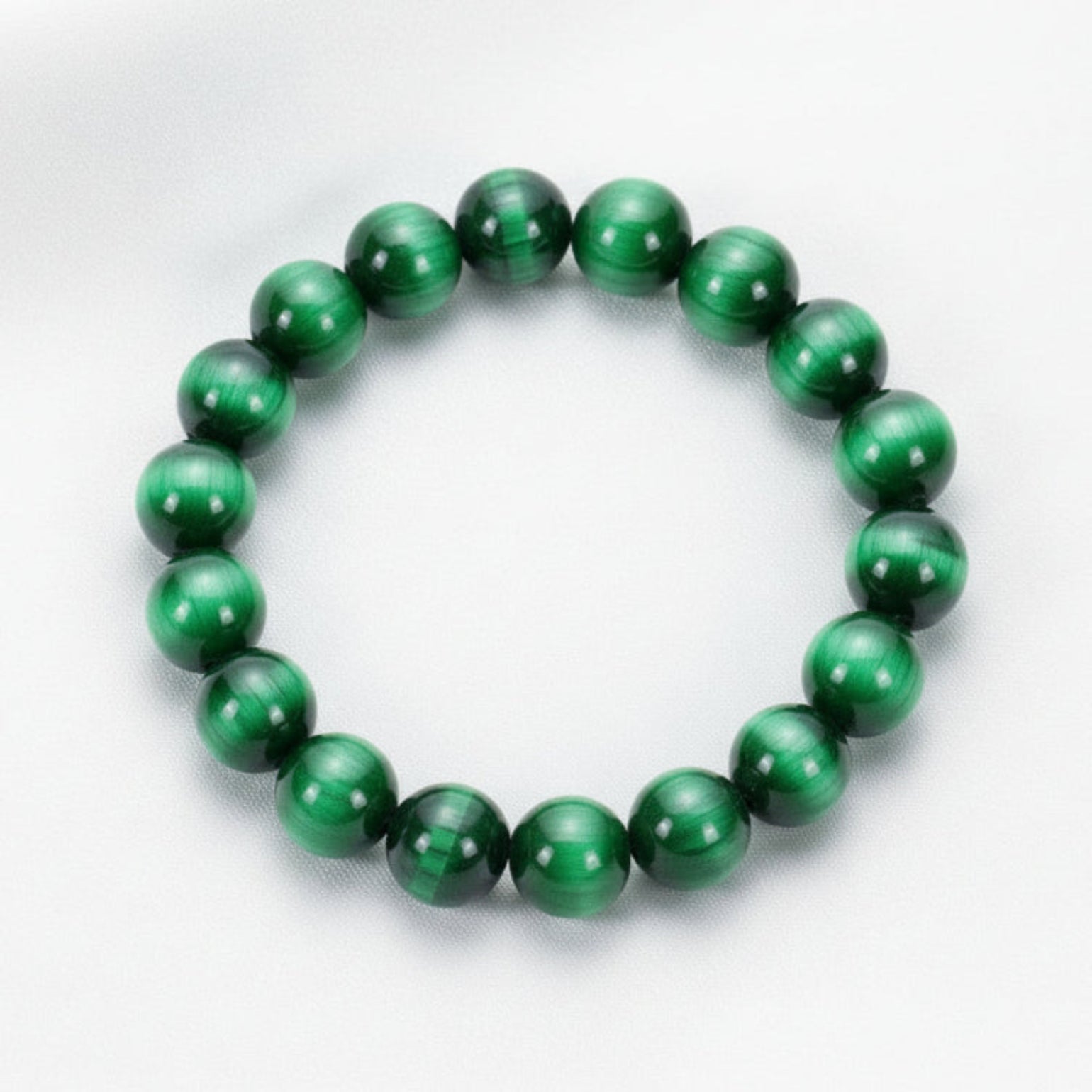 Green beaded bracelet on a white surface 