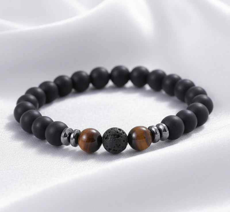Black beaded bracelet with brown and silver beads on a white surface