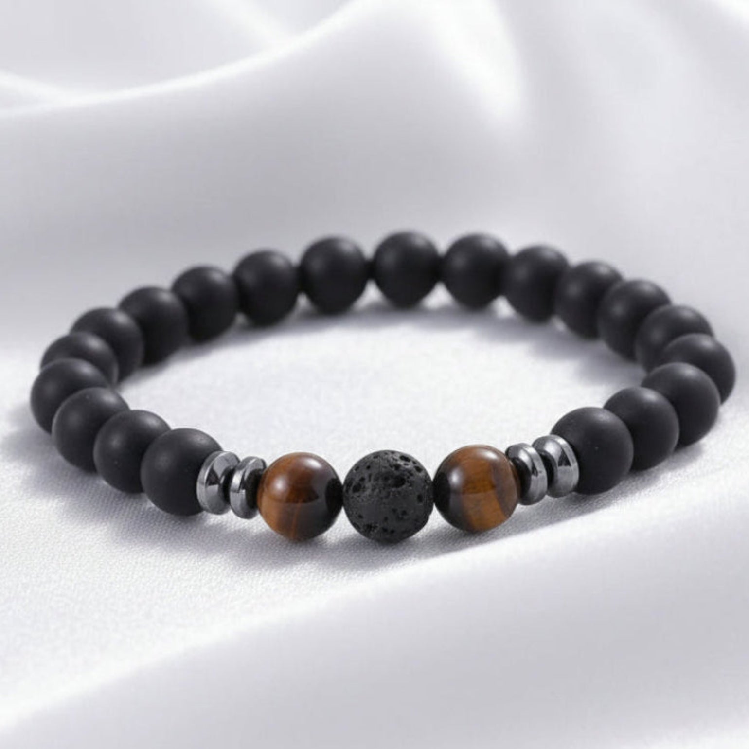 Black beaded bracelet with brown and silver beads on a white surface