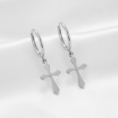 Silver hoop earrings with cross charms on a white background