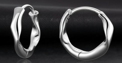 Pair of silver hoop earrings on a white background