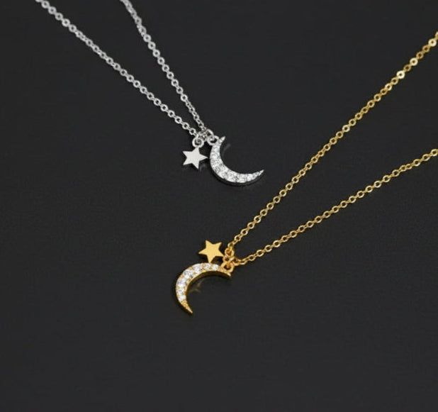 Two necklaces with moon and star pendants on a white background