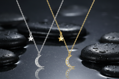 Two moon-shaped necklaces, one silver and one gold, on a white background.