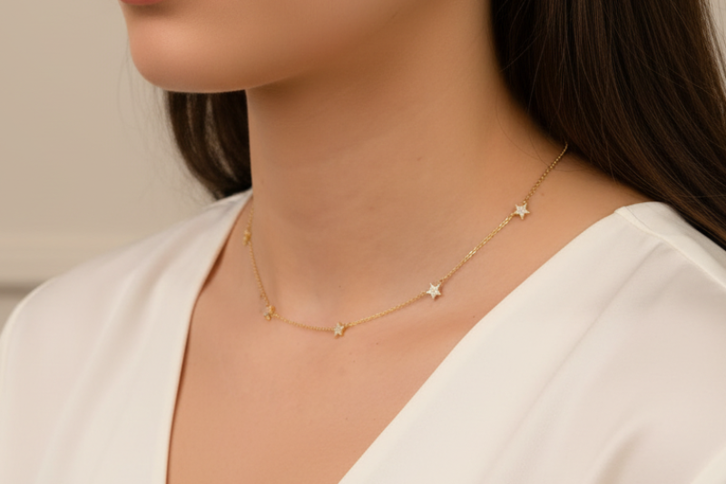 Gold necklace with small diamonds on a person's neck