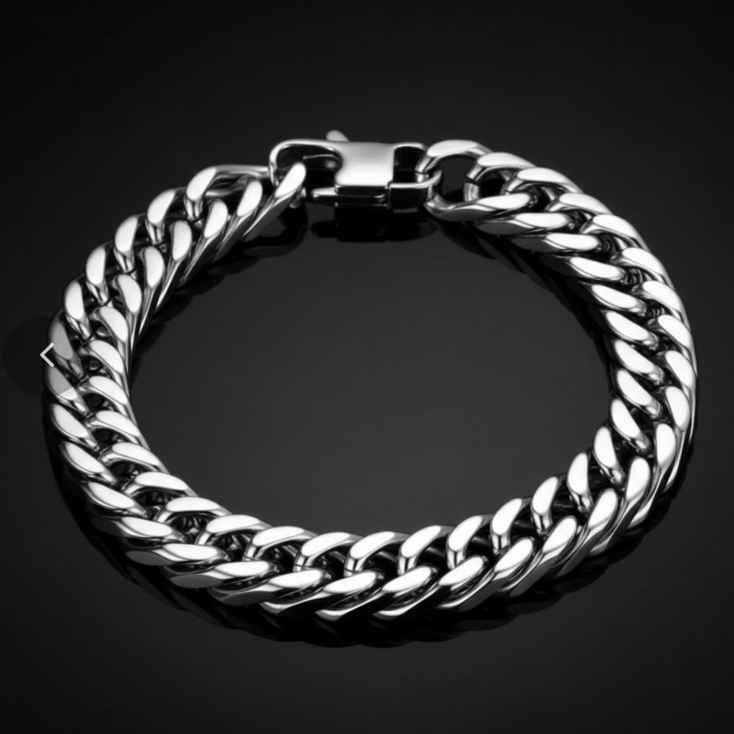 A thick silver-tone Cuban link chain bracelet with a polished clasp, displayed on a dark reflective surface.
