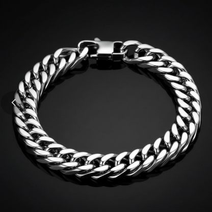 A thick silver-tone Cuban link chain bracelet with a polished clasp, displayed on a dark reflective surface.