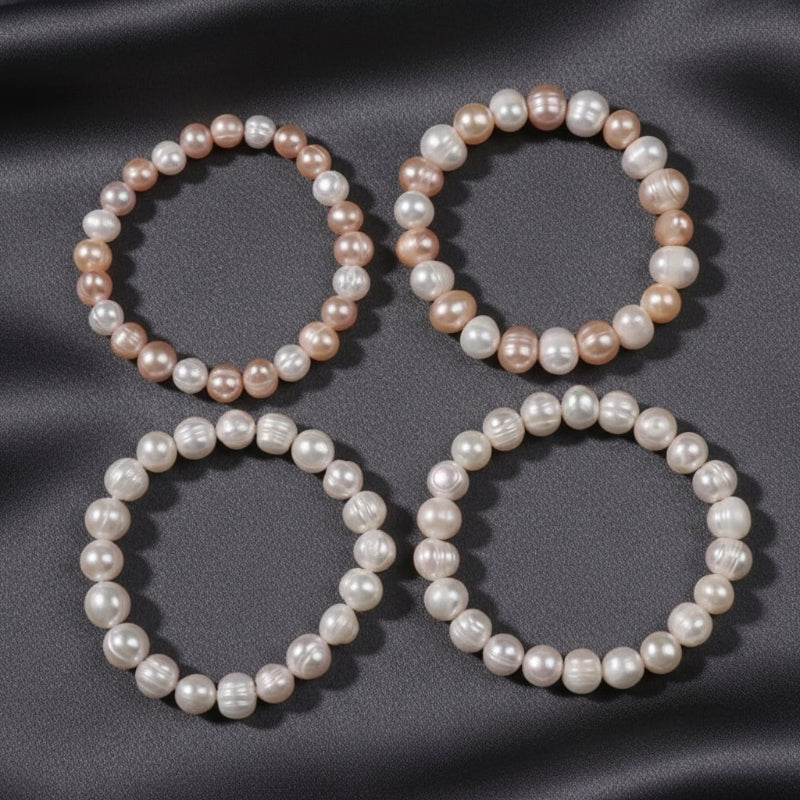 Three pearl necklaces on a grey surface