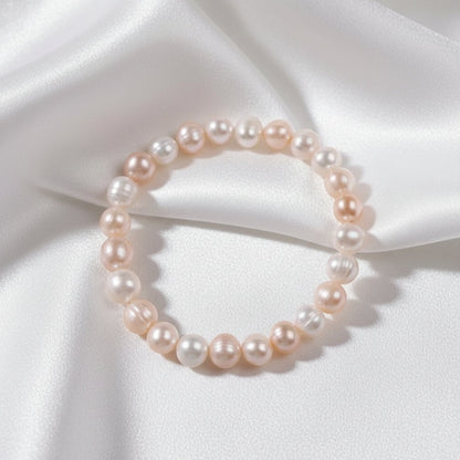 Pearl bracelet on a white fabric background