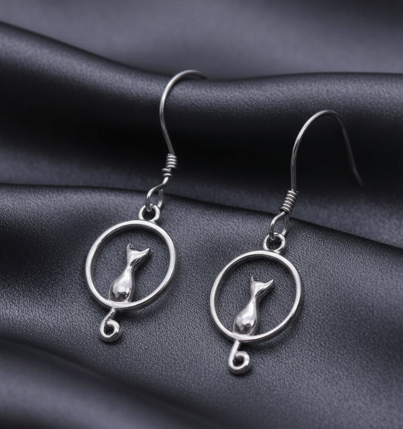 Silver cat-shaped earrings on a white background