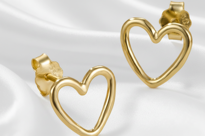 Gold heart-shaped earrings on a white background