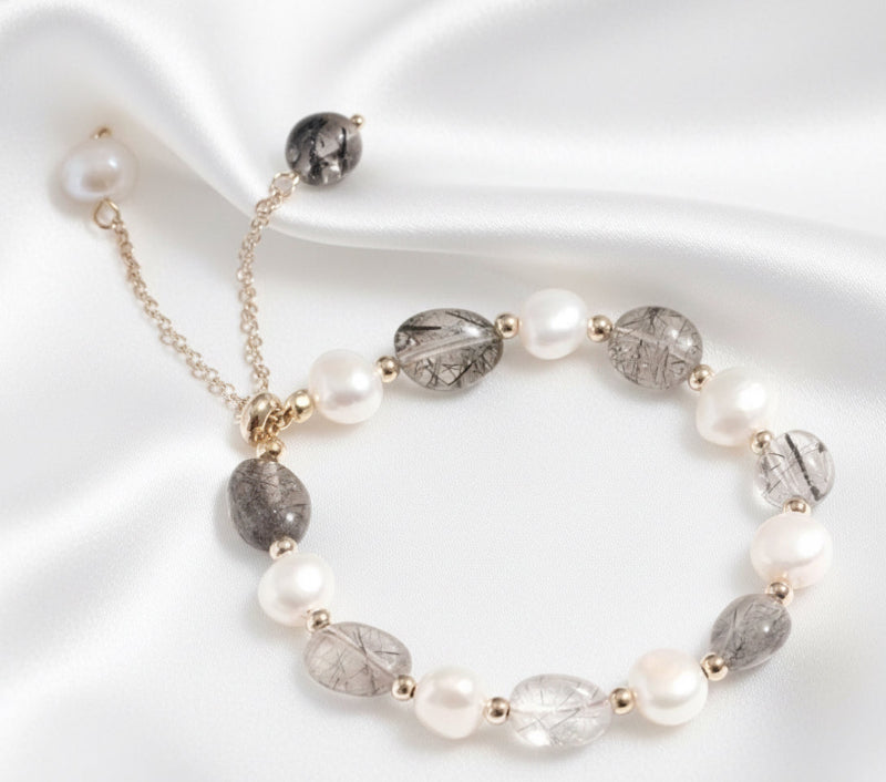 Necklace with pearls and gray beads on a white background