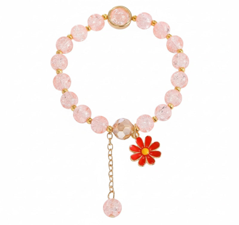 Pink beaded bracelet with a red flower charm on a white background