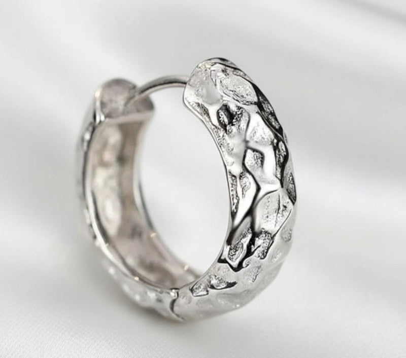 Silver hoop earring on a white background