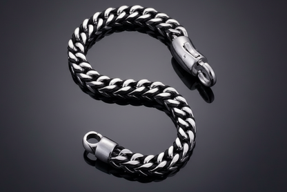Silver chain bracelet on a reflective black surface