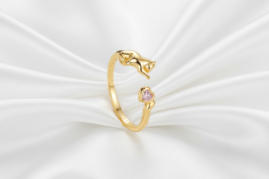 Two rings, one gold and one silver, on a light blue background