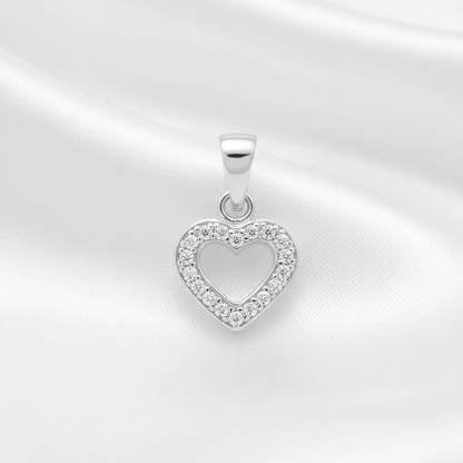 A silver heart-shaped pendant with a border of small clear stones, displayed on a white satin fabric background.
