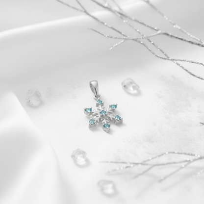 Aqua cubic zirconia silver snowflake pendant on a white background