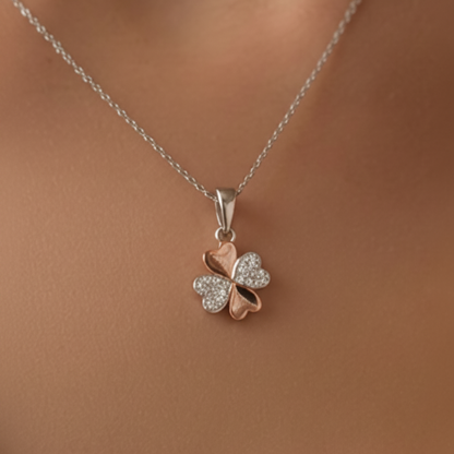 Sterling silver and rose gold plated clover pendant on a chain on a model