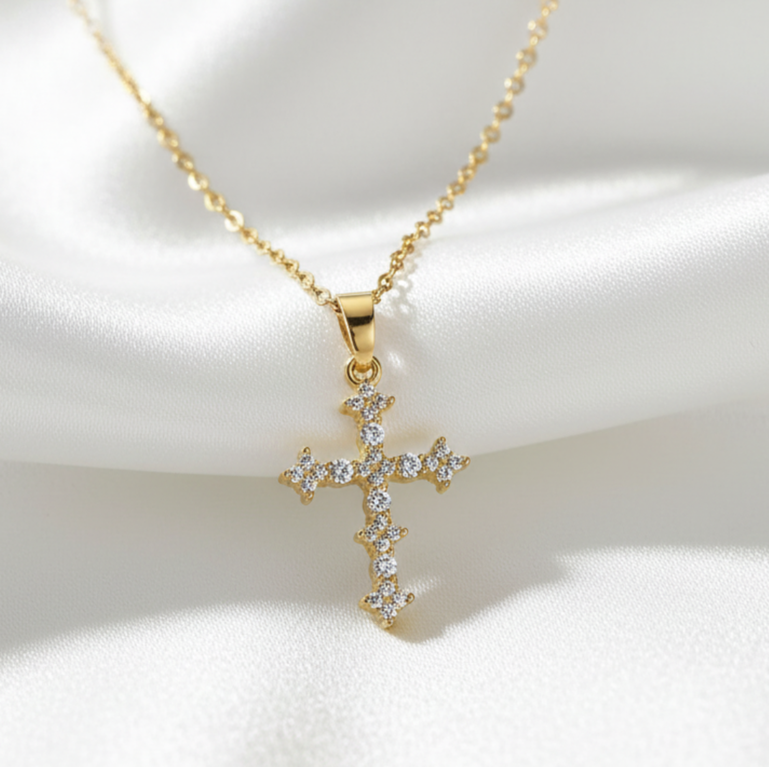Cross pendant on white satin