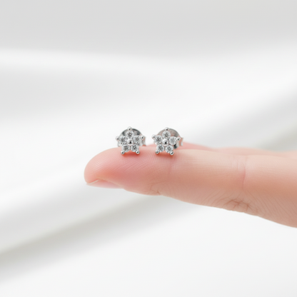 Flower ear studs on fingertip