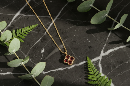 Garnet Necklace on Dark Marble with Greenery