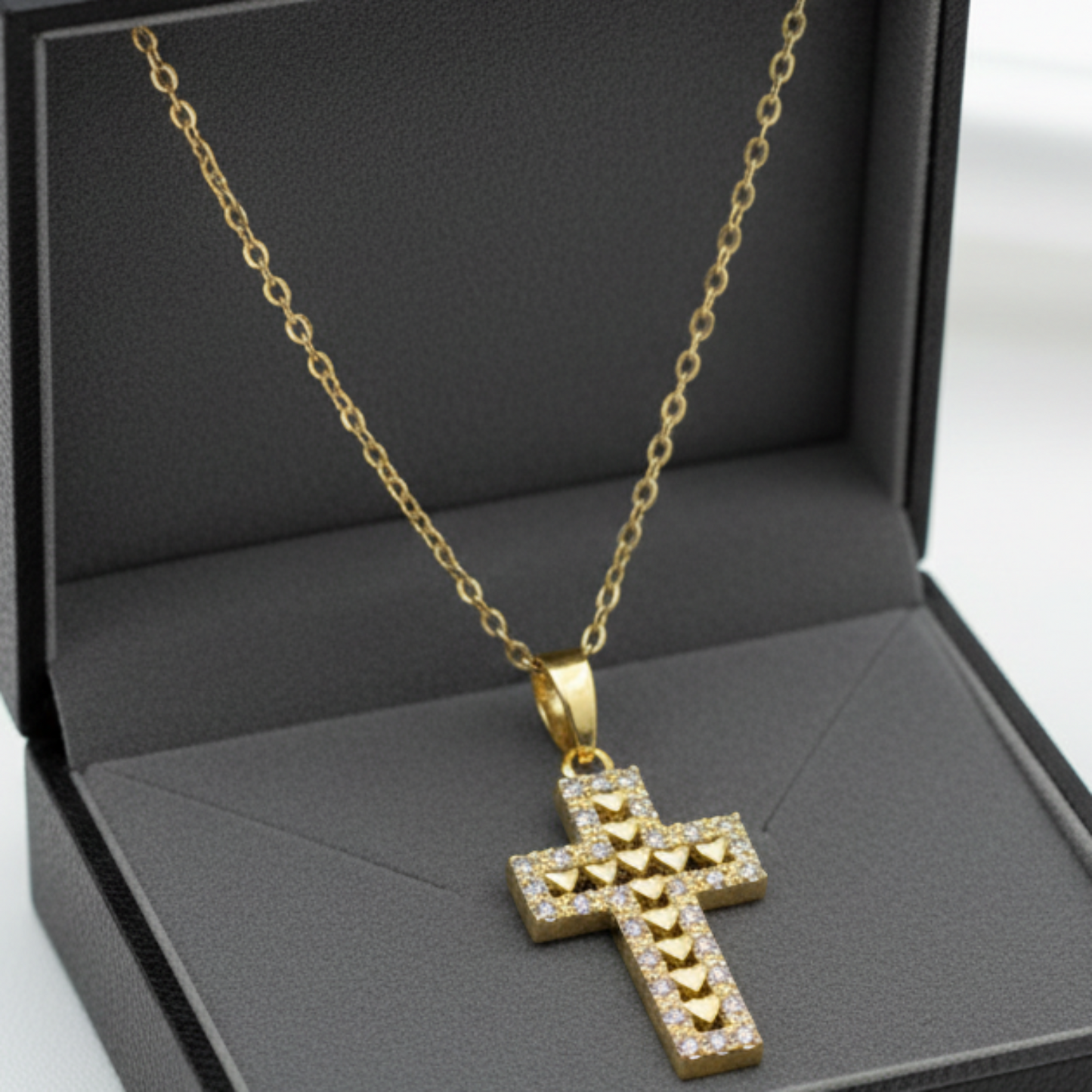 Gold cross pendant in jewellery box