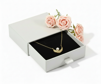 Gold necklace in grey box with pink roses