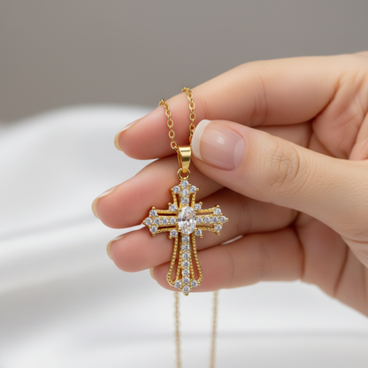 Hand holding ornate cross pendant