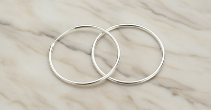 Hoop Earrings on Marble Surface