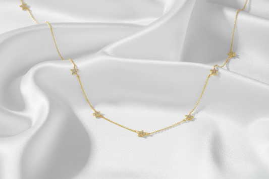 Gold necklace on a white satin background