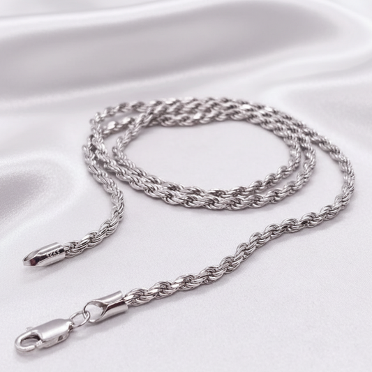 Silver chain necklace on a light gray background