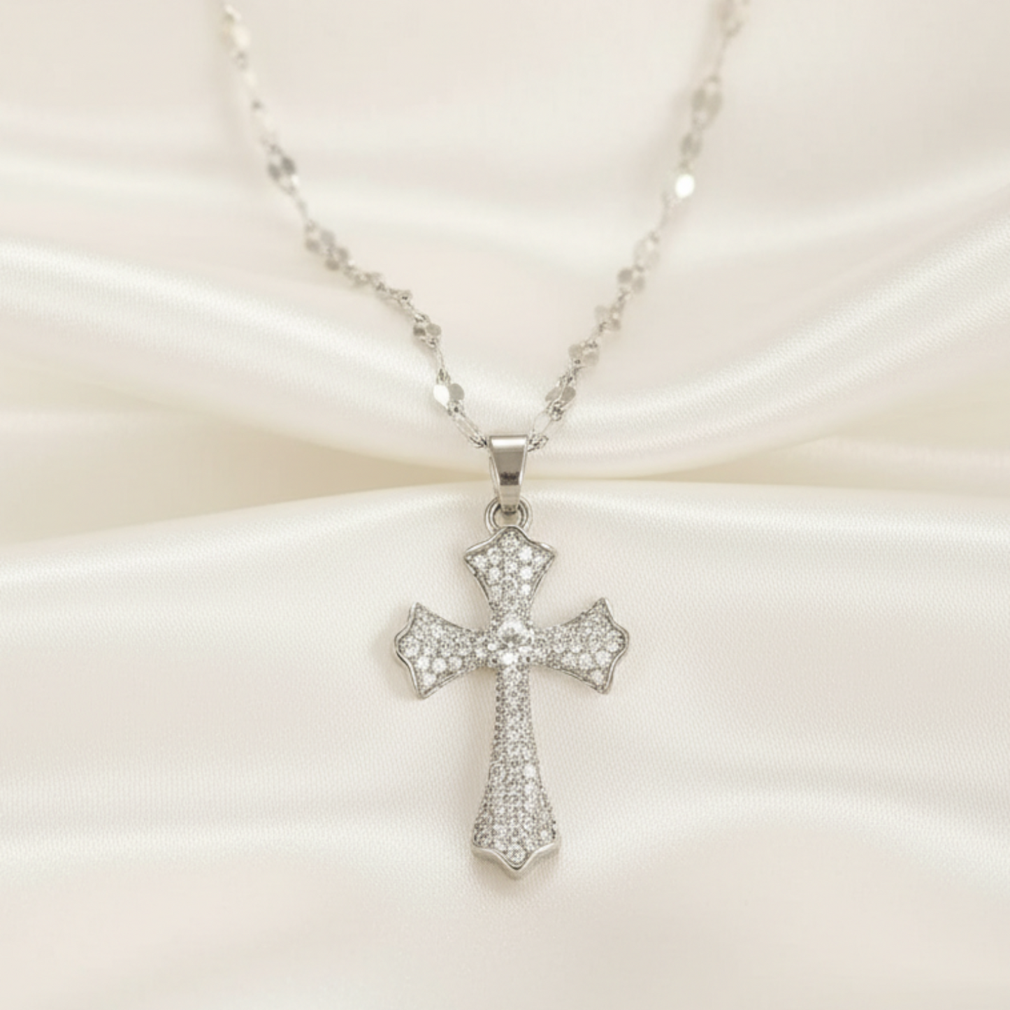 Silver cross necklace on a white background 