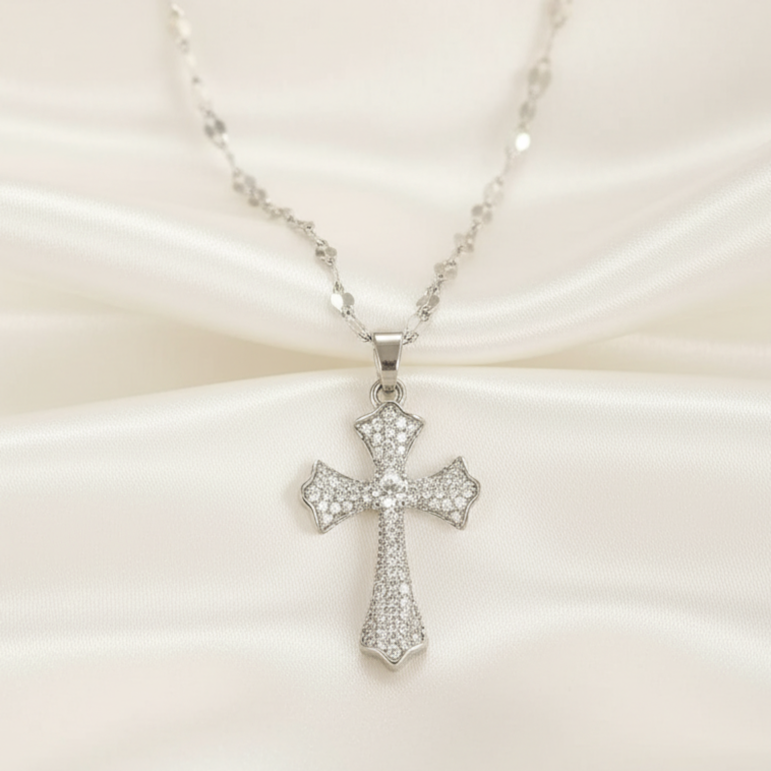 Silver cross necklace on a white background 