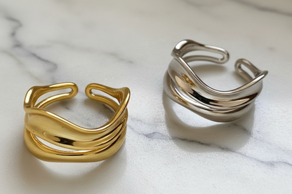Gold and silver rings on a textured surface