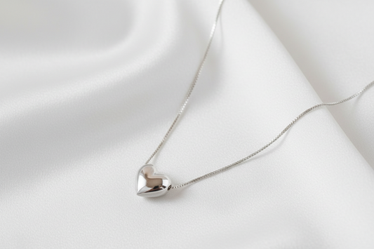 Silver heart-shaped pendant necklace on a light background