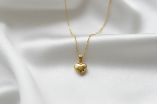 Gold heart-shaped pendant necklace on a card with text
