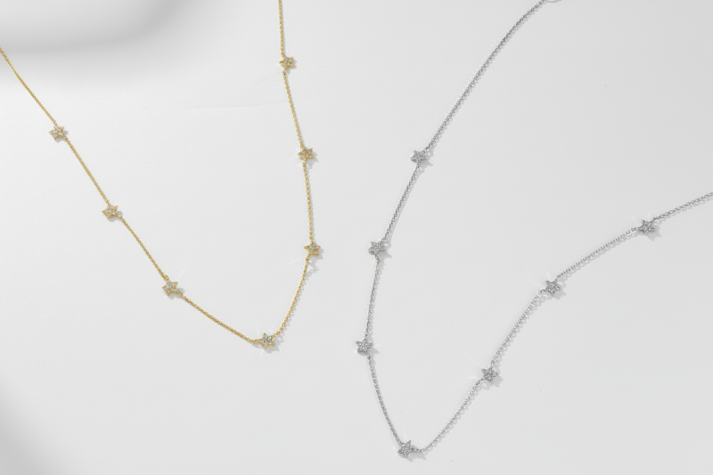 Two gold necklaces on a white background