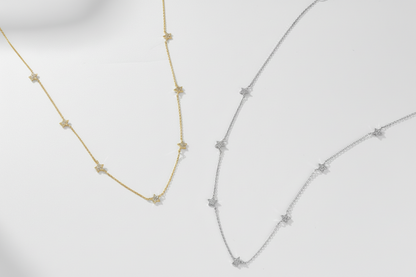 Two gold necklaces on a white background