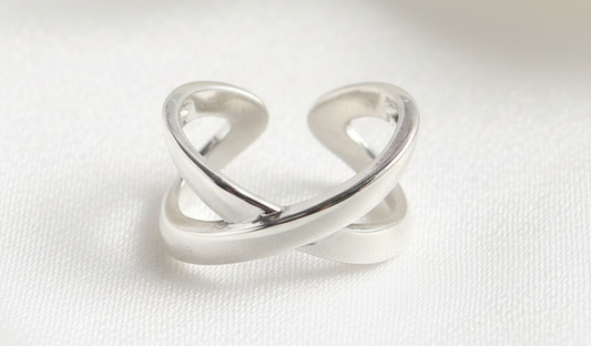 Silver open ring on a gray background