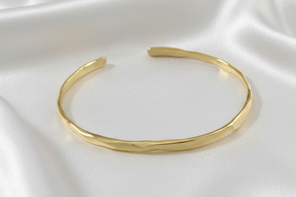 Gold bracelet on a white background