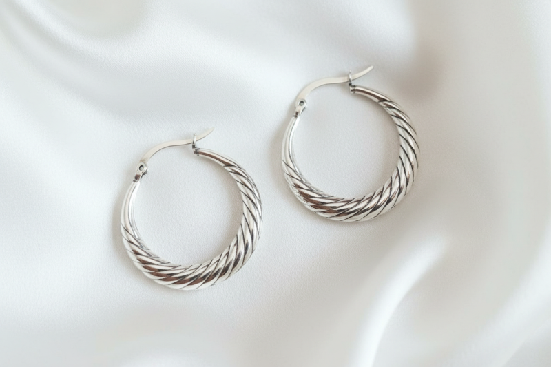 Pair of silver hoop earrings on a white background