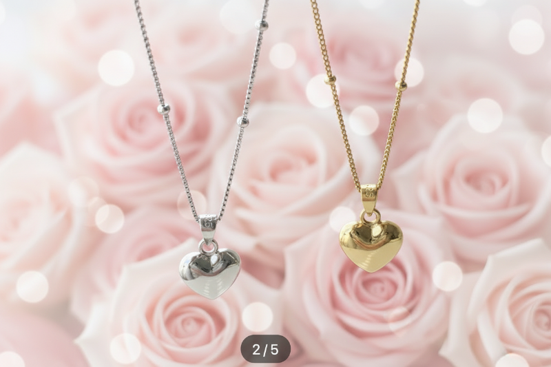 Two heart-shaped pendants on necklaces against a pink rose background
