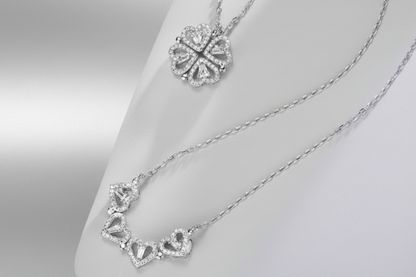 Silver necklaces with intricate designs on a neutral background