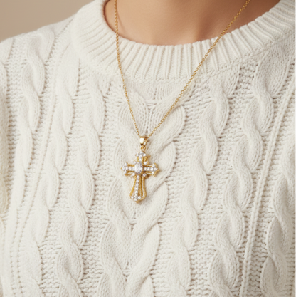 Ornate cross pendant over white jumper