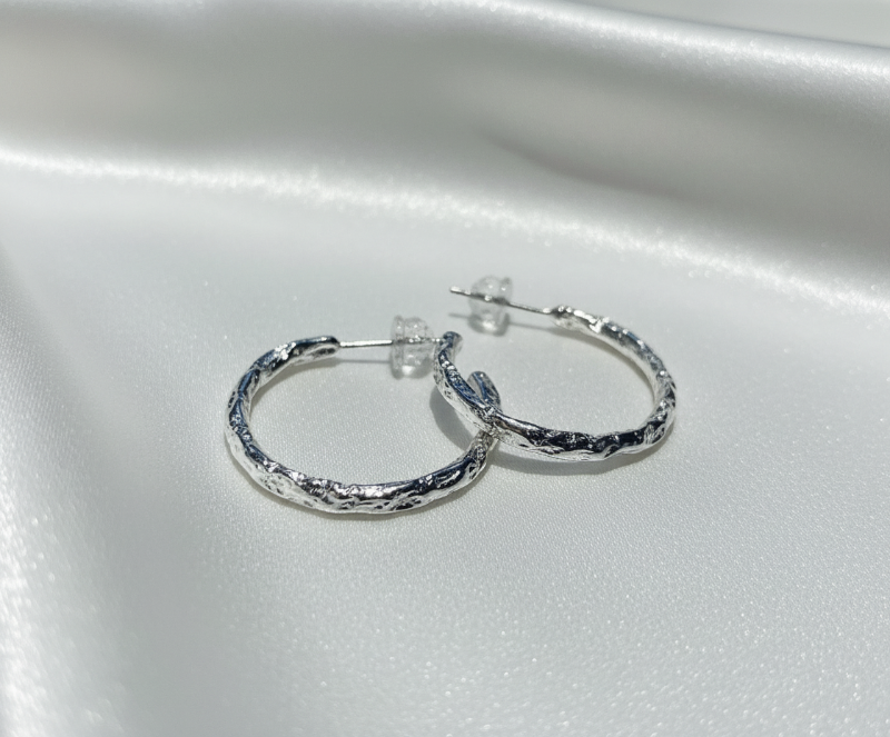 Silver hoops on white silk