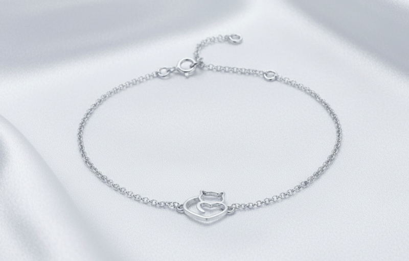 Sterling silver cat bracelet on white silk background
