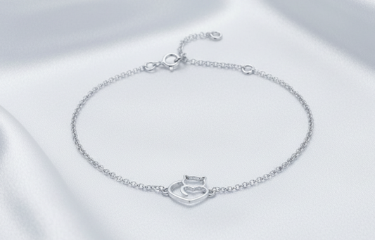 Sterling silver cat bracelet on white silk background