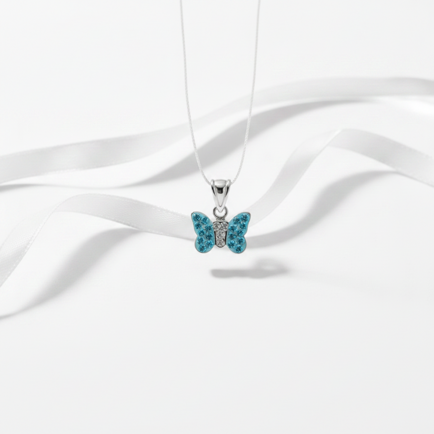 Thin flat pendant blue butterfly crystals on sterling silver with white background