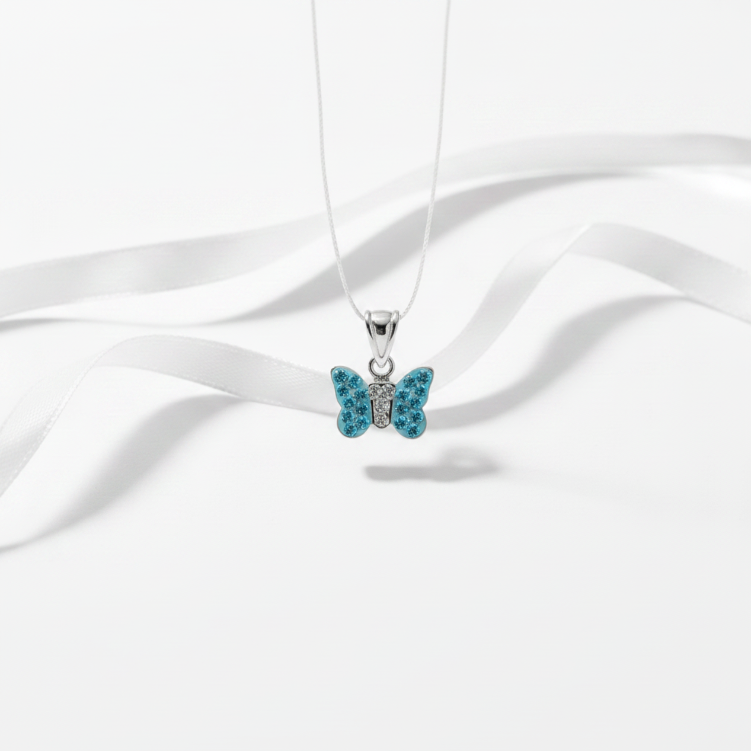 Thin flat pendant blue butterfly crystals on sterling silver with white background